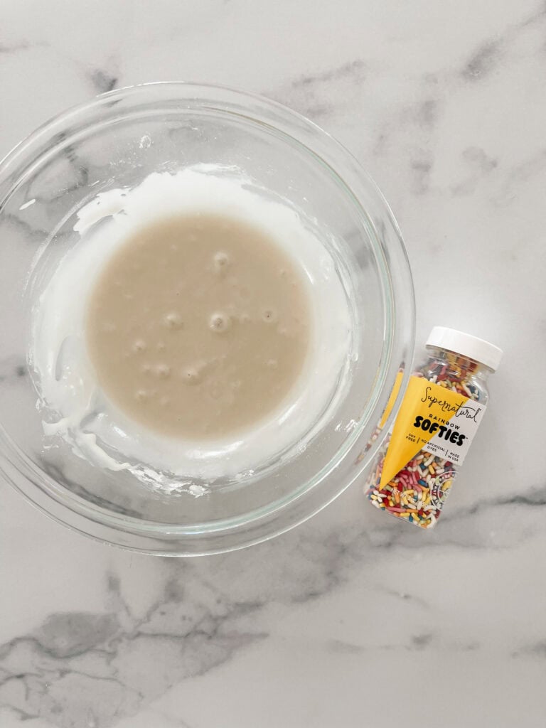 Sprinkles and glaze in a bowl.