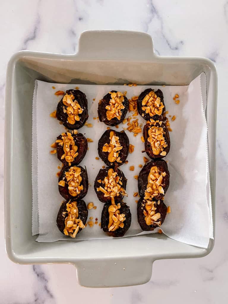 Dates filled with peanut butter and sprinkled with peanuts. 